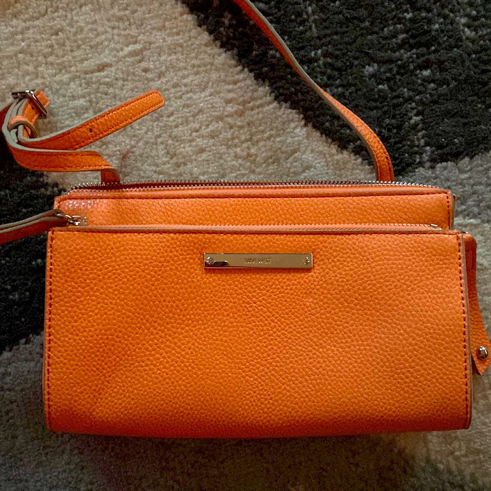 NINE WEST purse, orange in color and very good condition, never been used.